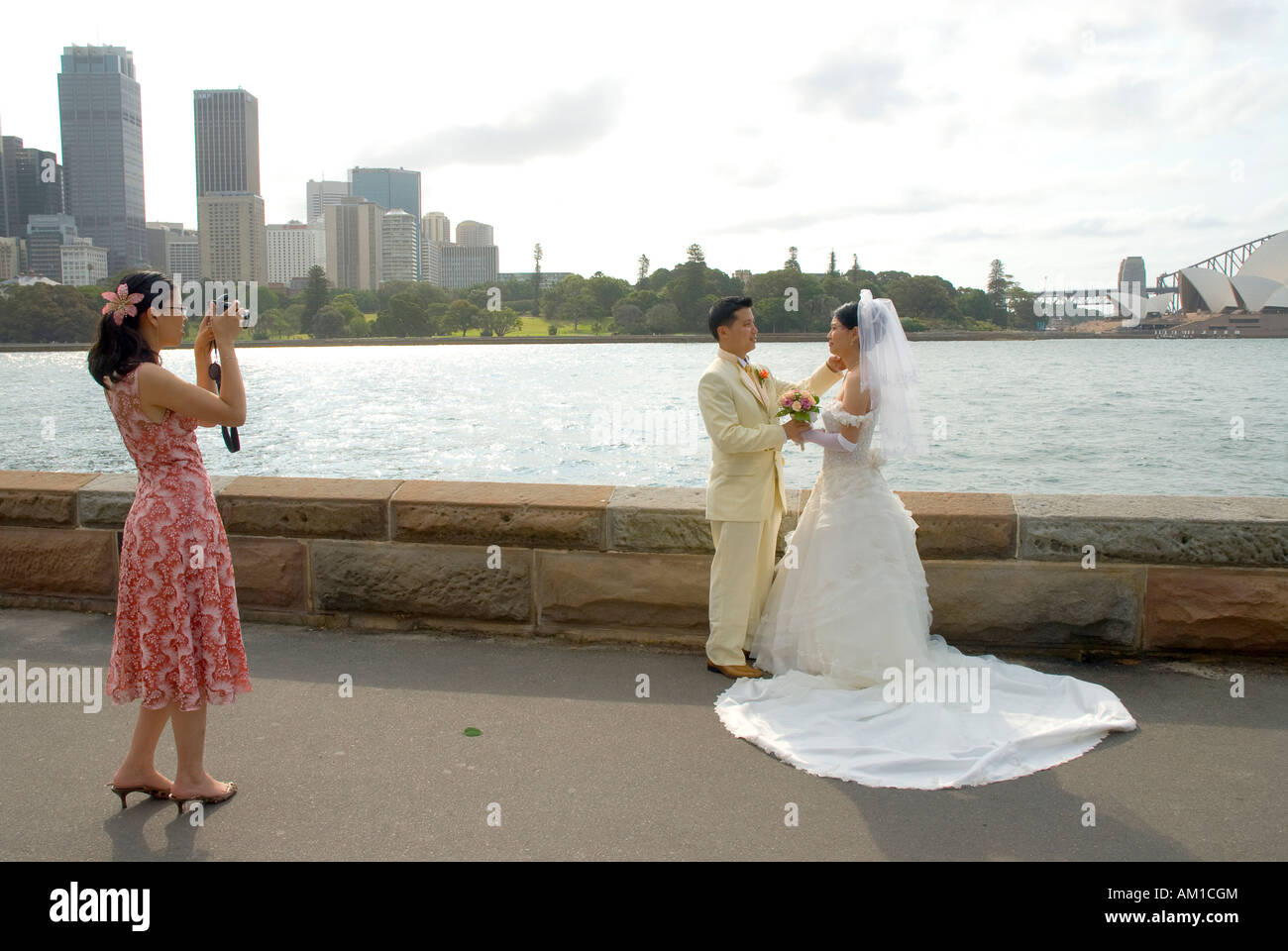 Taking pictures of a married couple before the harbour and Opera House scenery, Port Jackson, Sydney, New South Wales, Australia Stock Photo