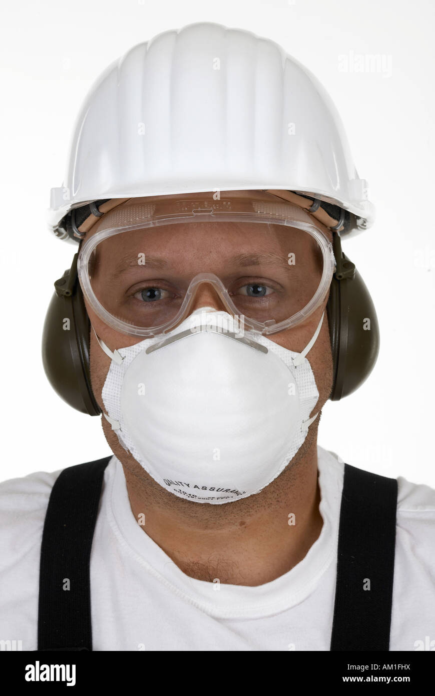 Craftsman with protective goggles, face mask, ear protection and helmet Stock Photo