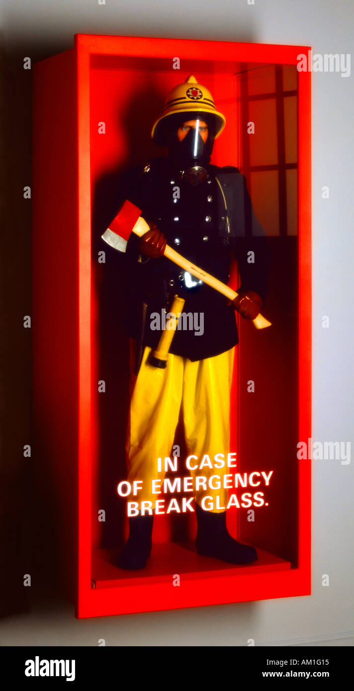 Fireman in glass case ' in case of fire break glass'. Stock Photo