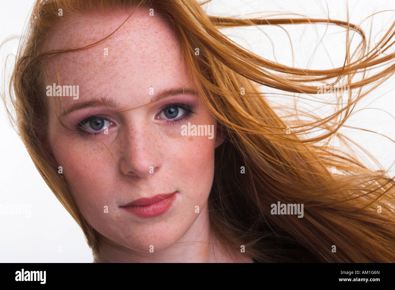 Ortrait of a girl with moving red hair and freckles Stock Photo