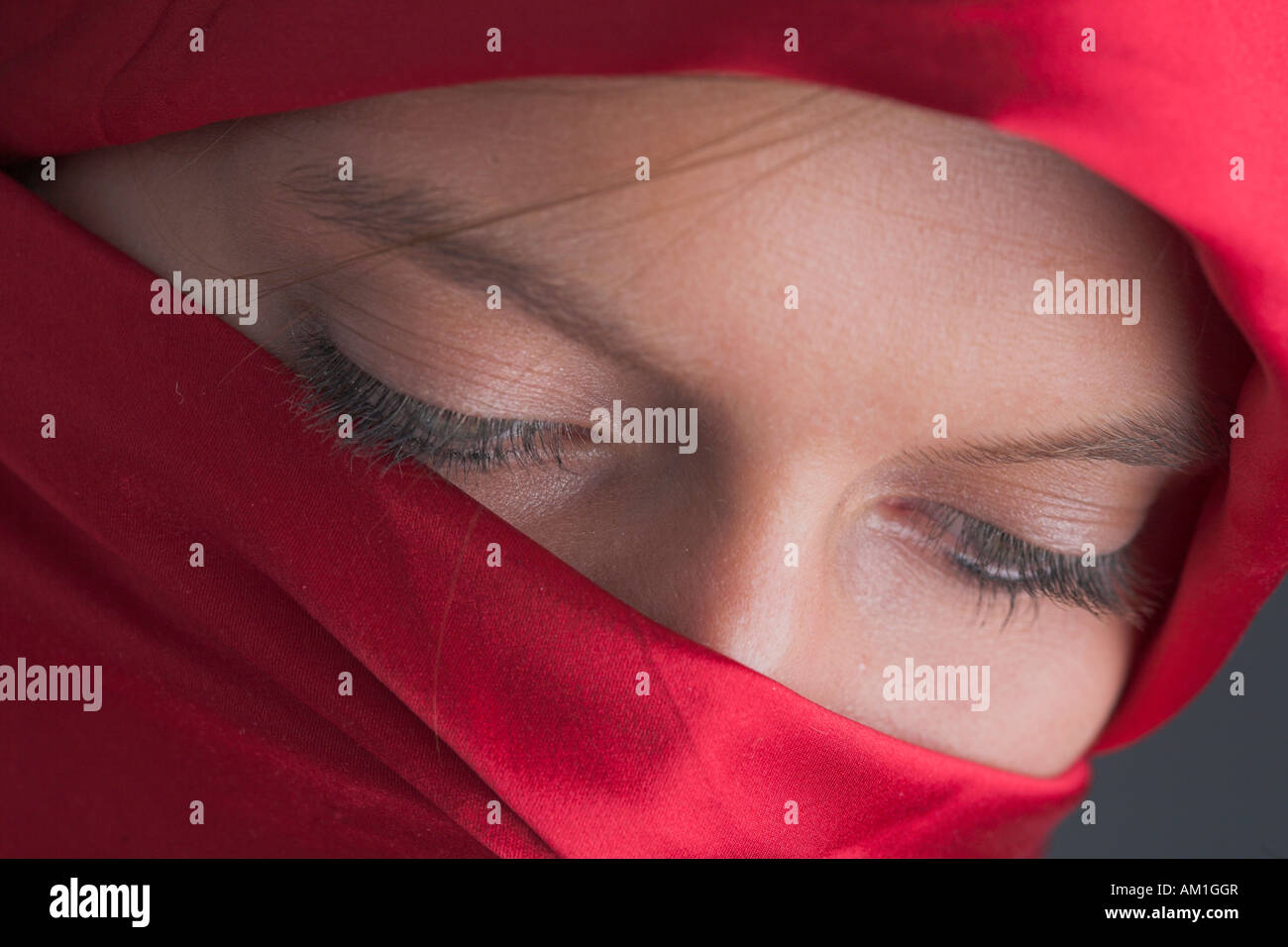 Veiled, young woman looking down Stock Photo