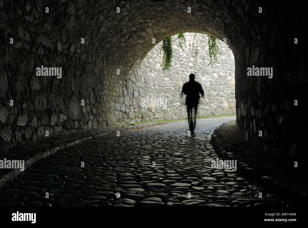 A man going trough the tunnel from the castle ruins on hohentwiel - Baden-Wuerttemberg, Germany, Europe. Stock Photo