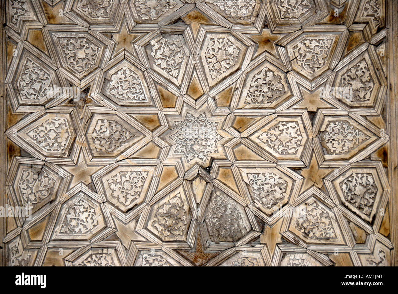 Geometric wood carving at the entrance gate to Madrasah Kukeldash Bukhara Uzbekistan Stock Photo