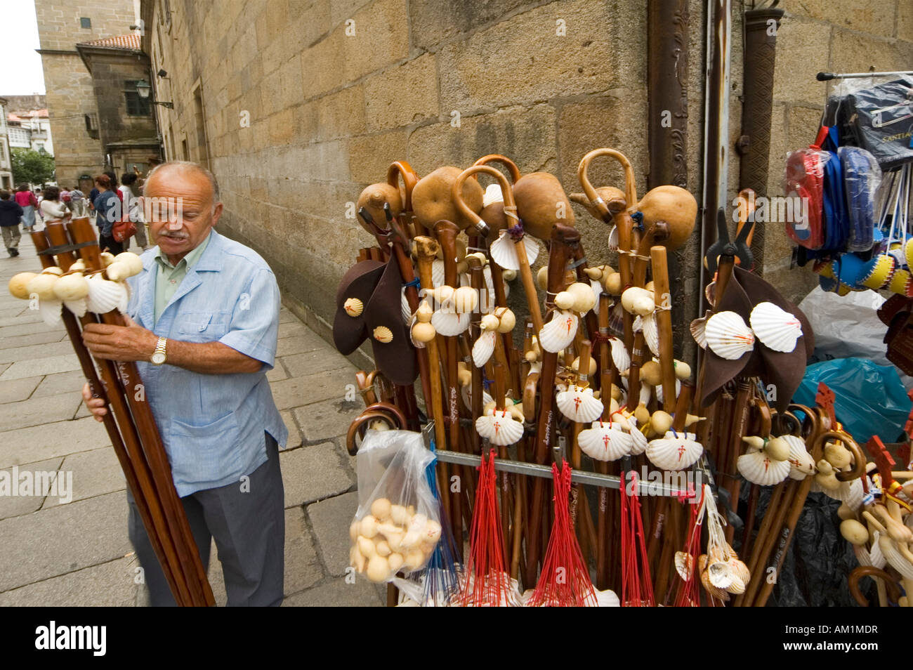 Souvenir salesman with hiking poles and scallops in front of the cathedral, Santiago de Compostella, Galicia, Spain Stock Photo