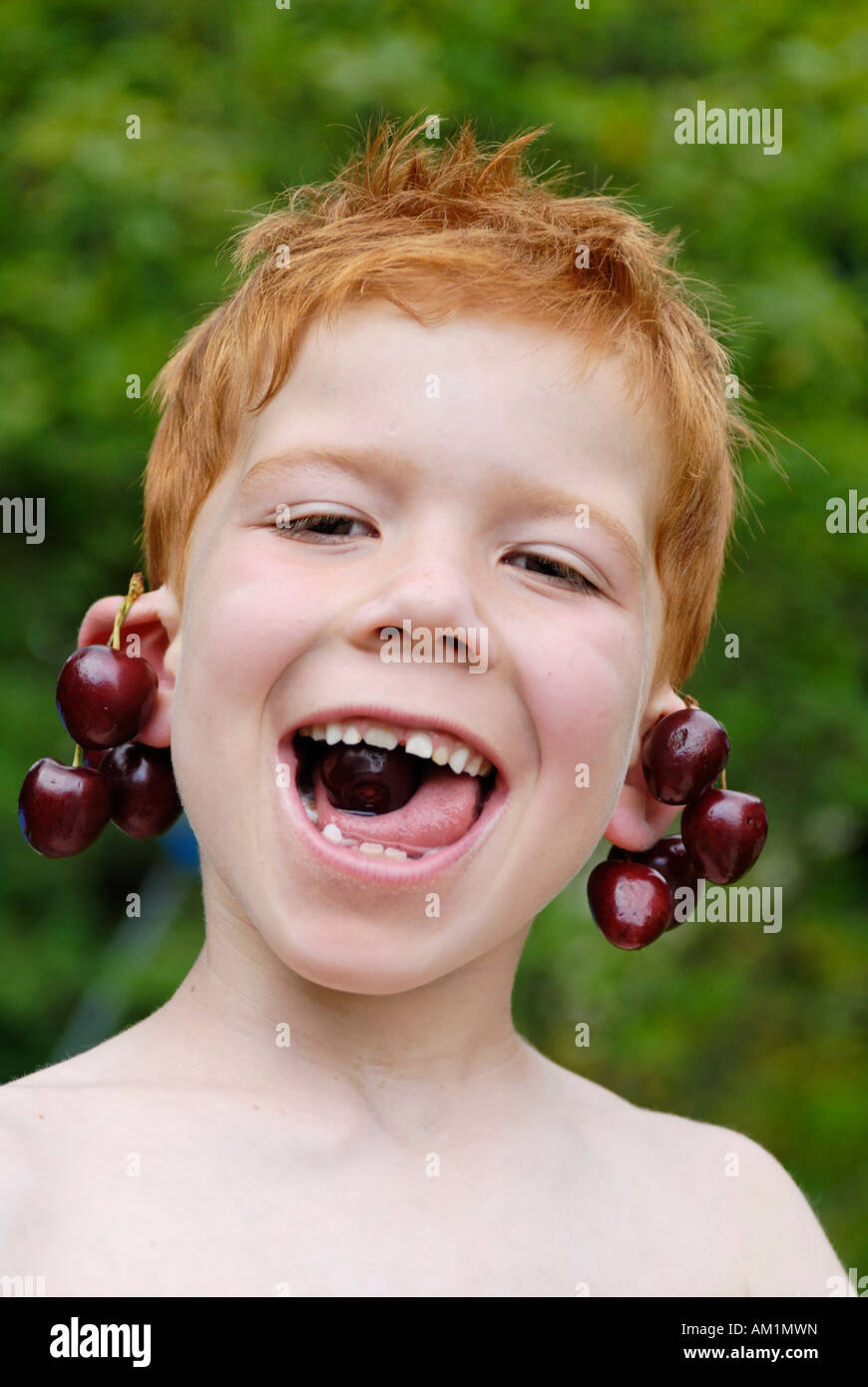 Boy enjoying cherries Stock Photo Alamy