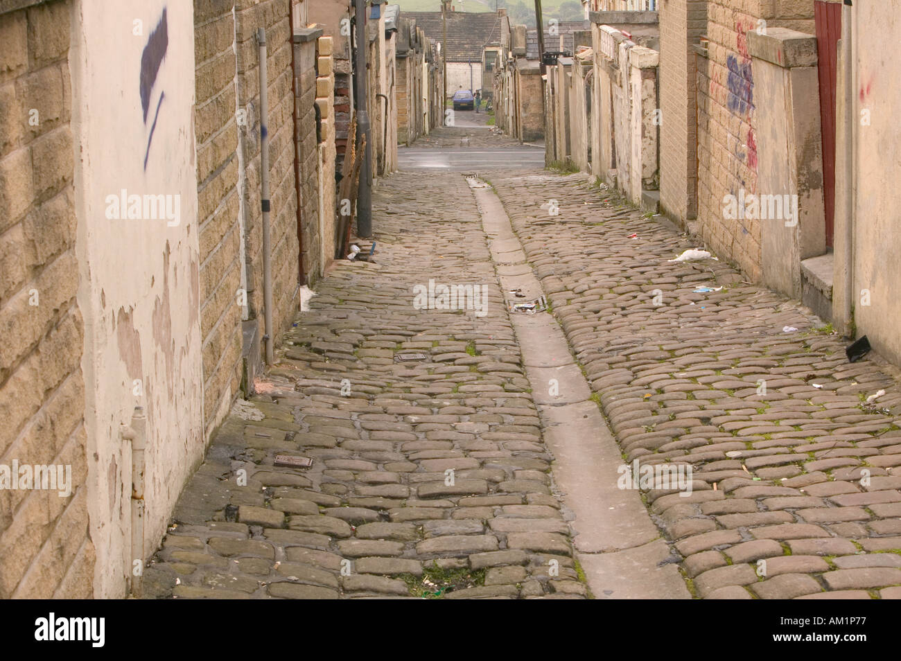 cobbled back alley behind traditional Lancashire terraced houses in an asian area of Brierfield Lancashire Stock Photo