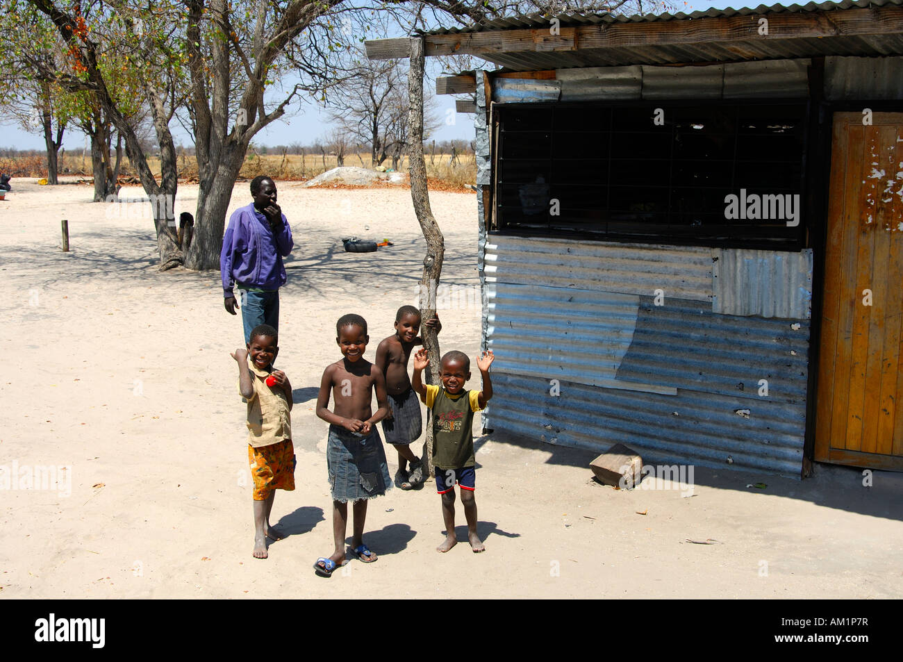 Smiling African kids in front of a poor dwelling, Botswana Stock Photo