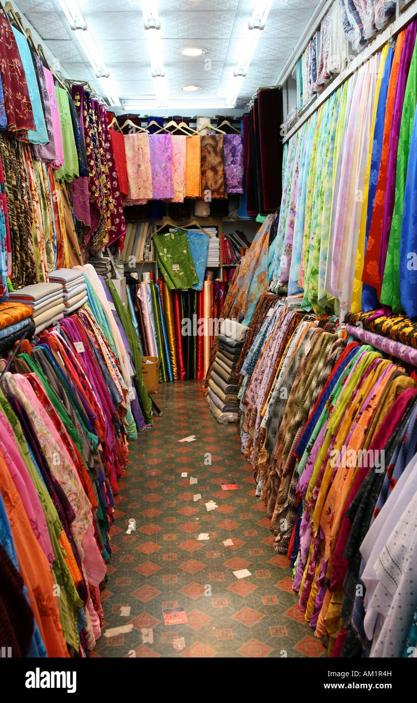 A typical small textile shop in the traditional souq at the heart of Doha Qatar Stock Photo