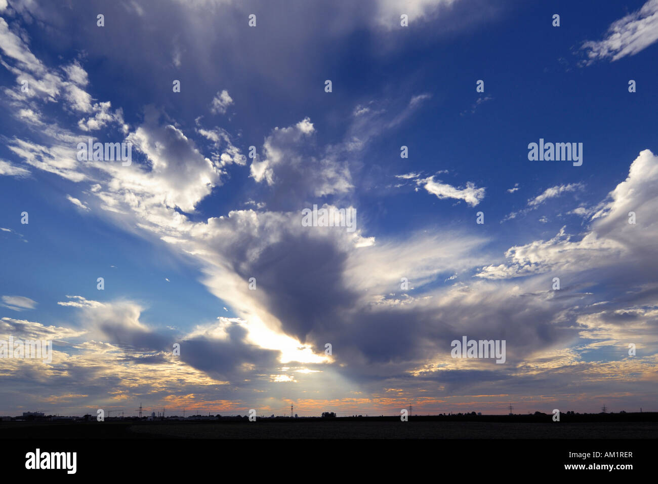 Cloud formation with sun and sunbeams in the evening Stock Photo