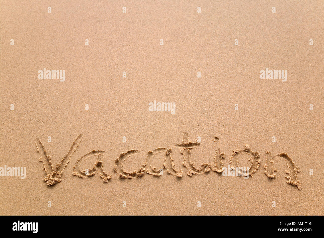 The word Vacation written in sand at the beach Stock Photo - Alamy