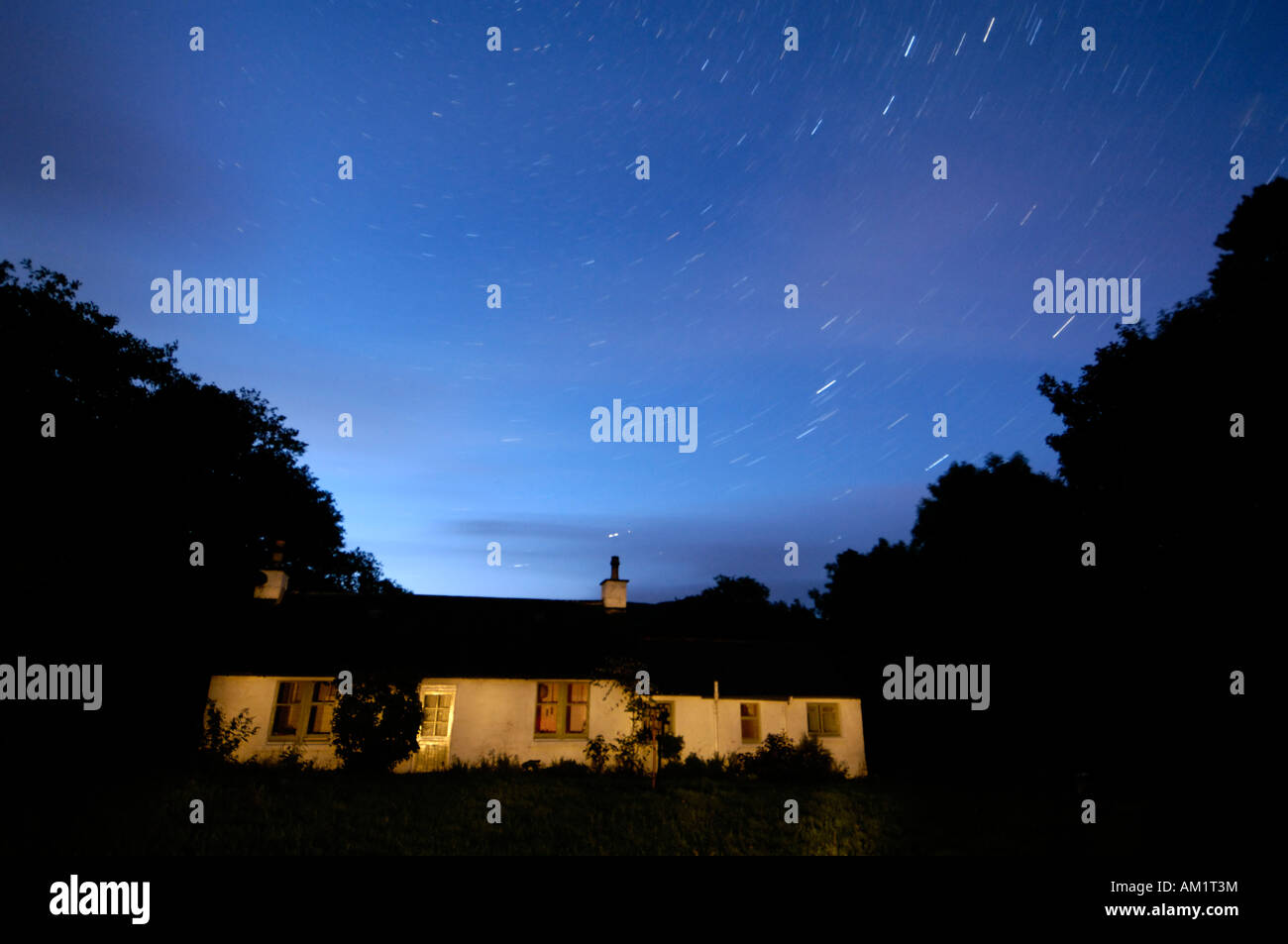 Stars at night over a traditional Scottish cottage, Dumfries and Galloway, Scotland Stock Photo