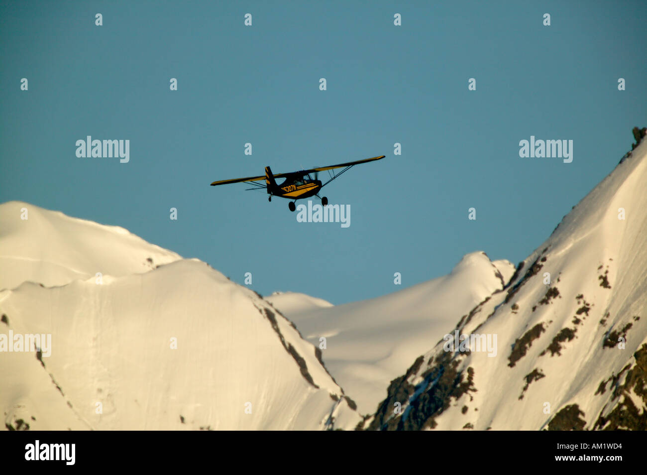 Bush plane flies over the Chugach National Forest Seward Alaska Stock