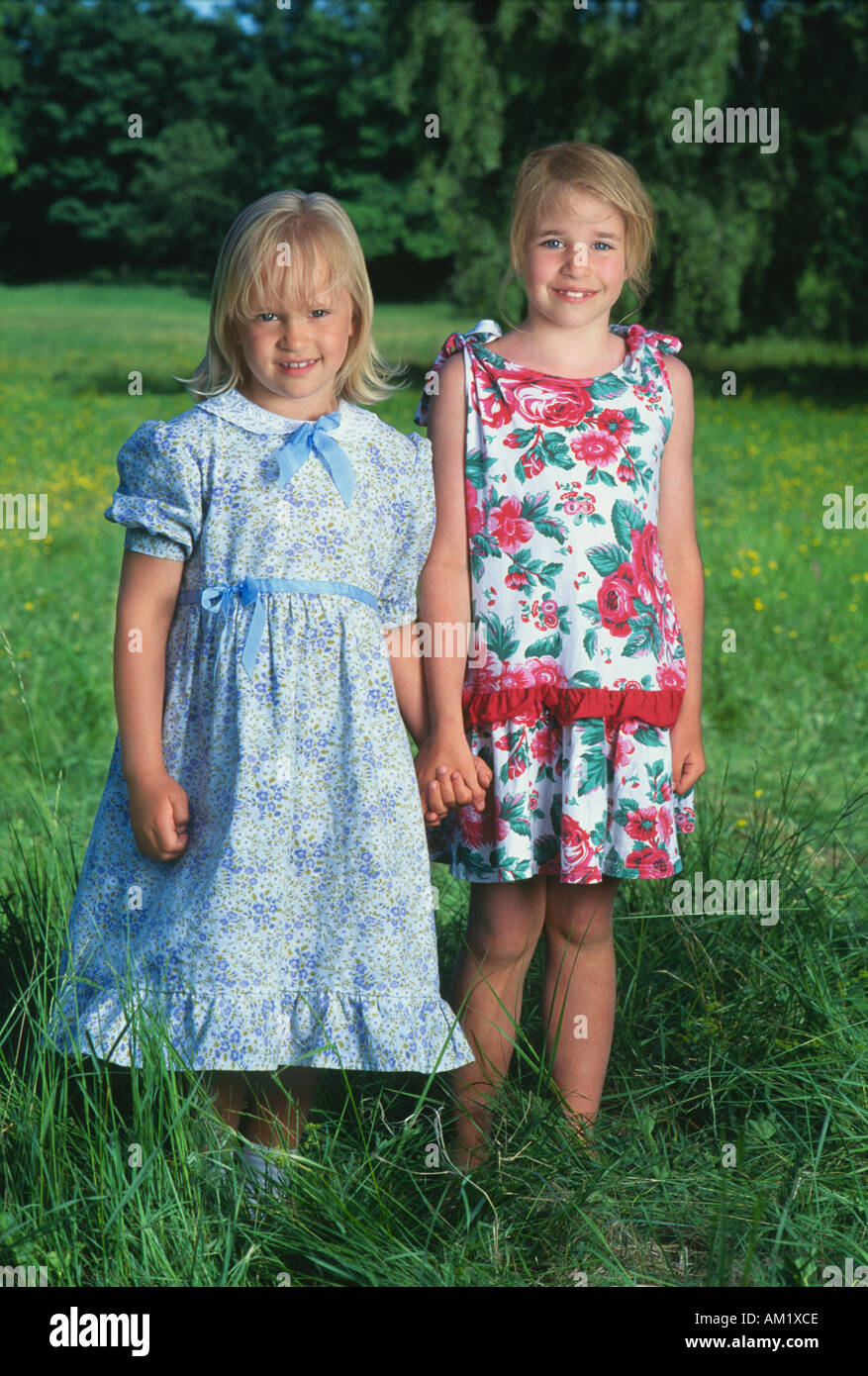 Two young Swedish girls wearing dresses posing for camera Stock Photo
