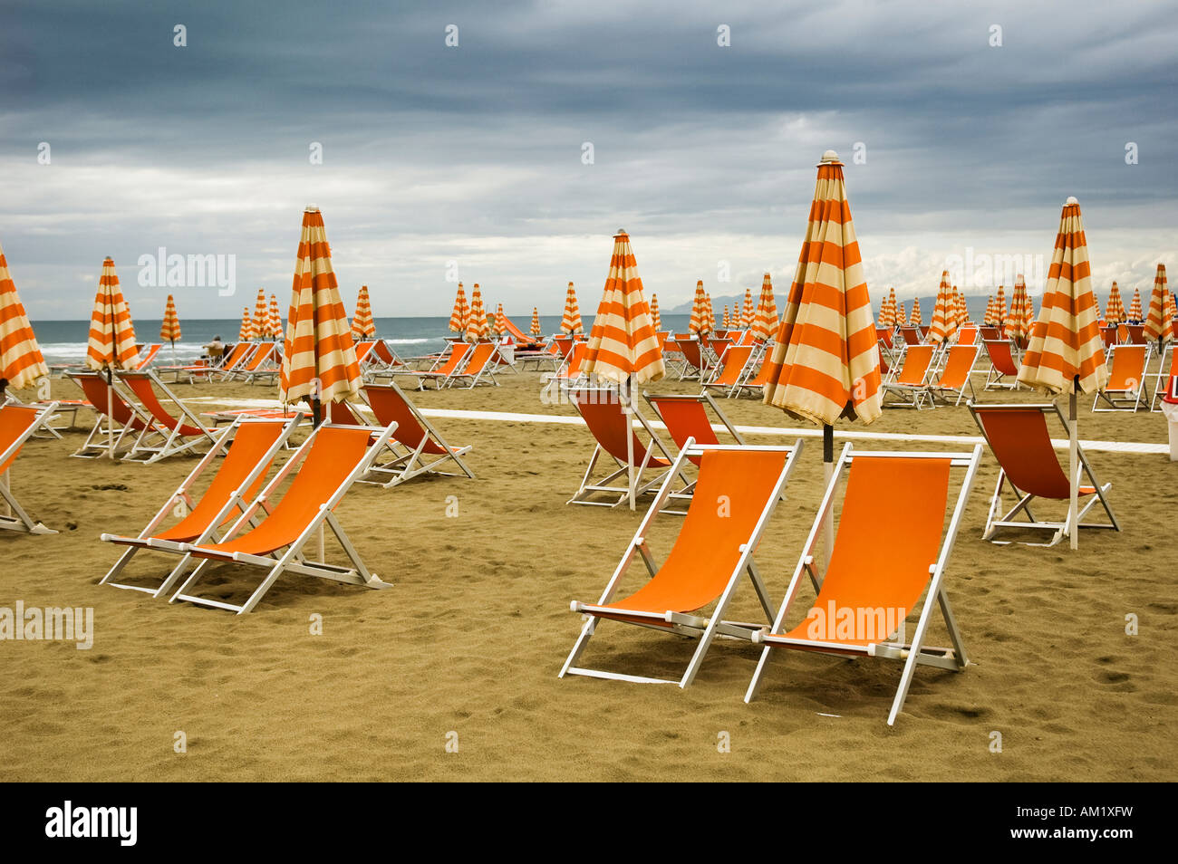 Orange deckchairs on a deserted beach in Viareggio Italy Stock Photo