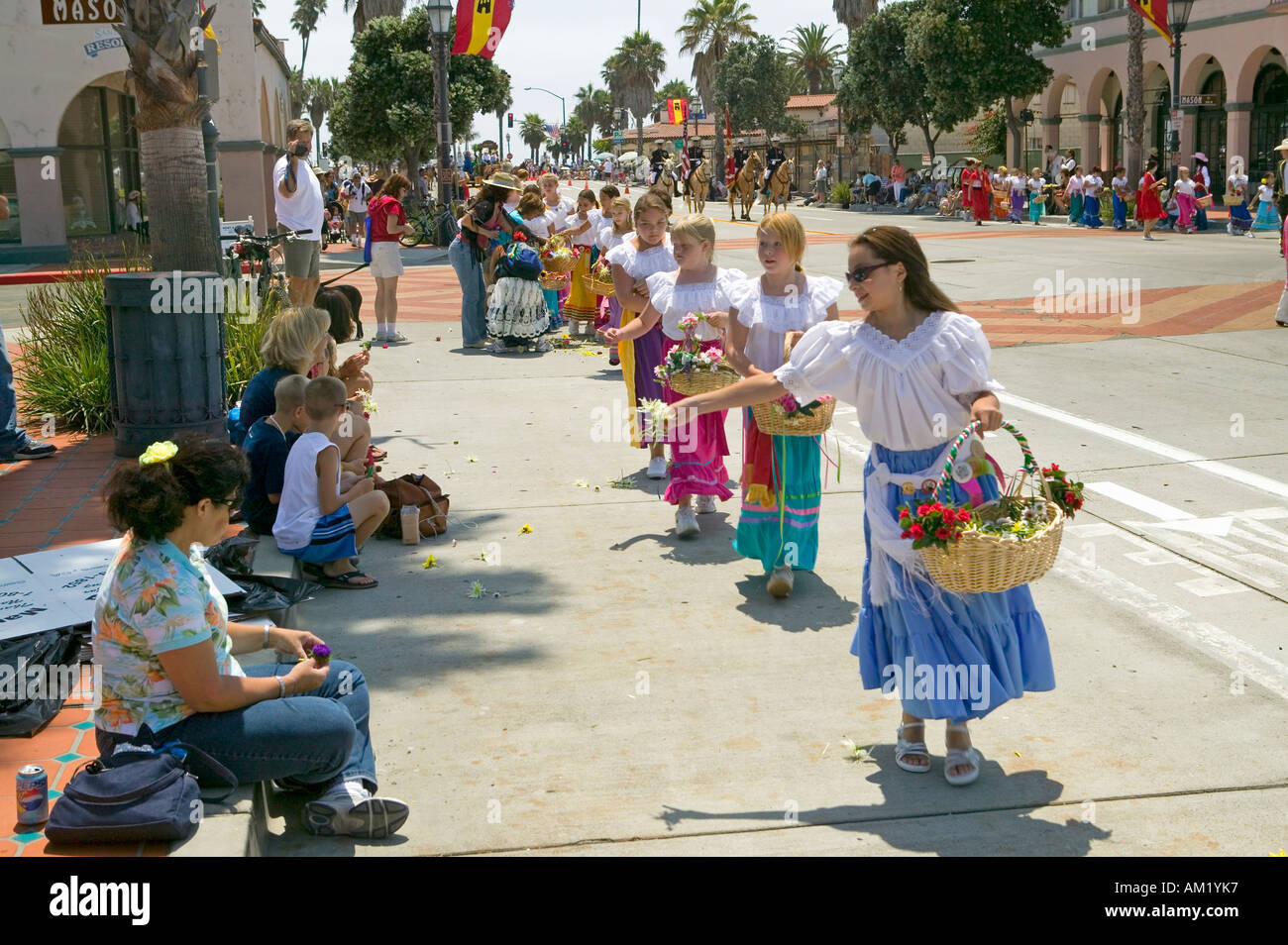 Flower girls throwing flowers during opening day parade down State