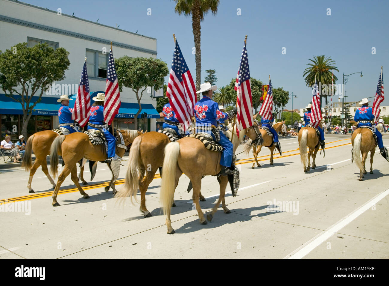 Cowboys marching with American Flags displayed during opening day