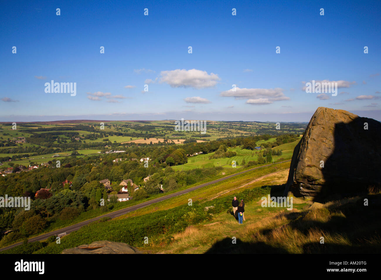 Admiring the view from Calf Rock at Cow and Calf Rocks on Ilkley Moor near Ilkley West Yorkshire England Stock Photo