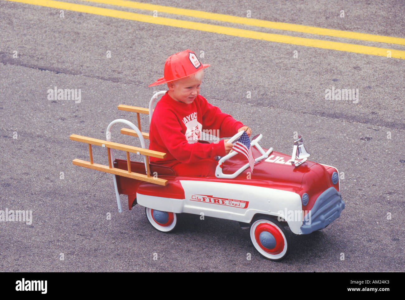 Boy in Toy Fire truck in July 4th Parade Cayucos California Stock Photo