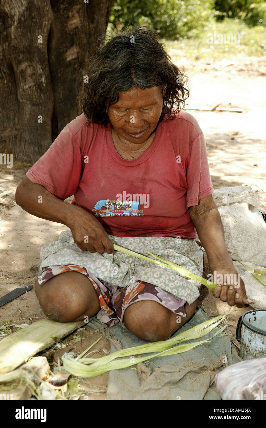Ayoreo Indian woman working with bromelain fibres for knotting arts and