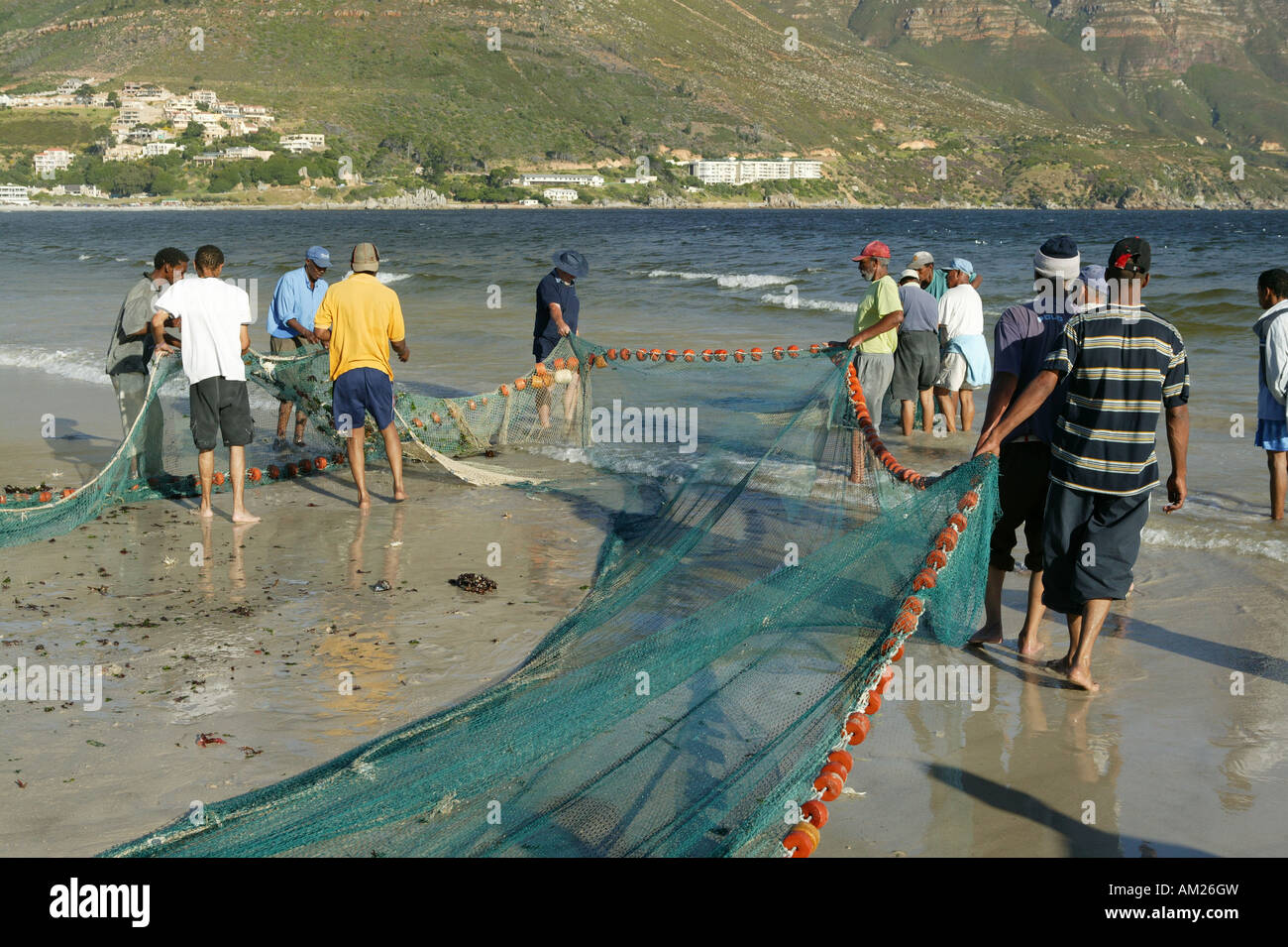 Fishermen on the beach with flues, Hout Bay, Cape Town, South Africa Stock Photo