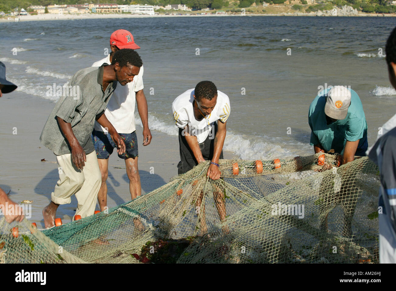 Fishermen on the beach with flues, Hout Bay, Cape Town, South Africa Stock Photo