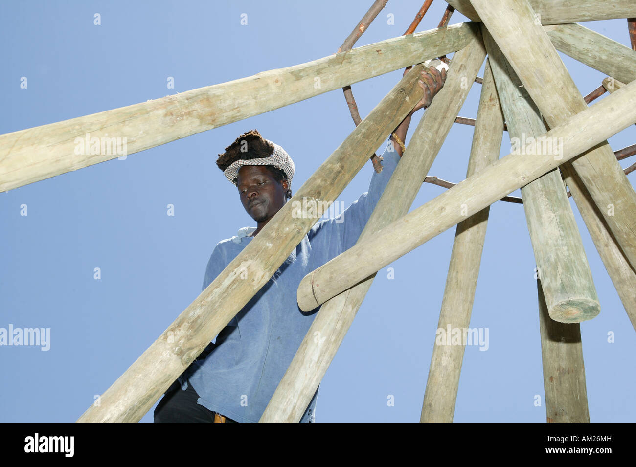 Man building a truss of a traditionial round hut, Rasta Community, Cape Town, South Africa Stock Photo