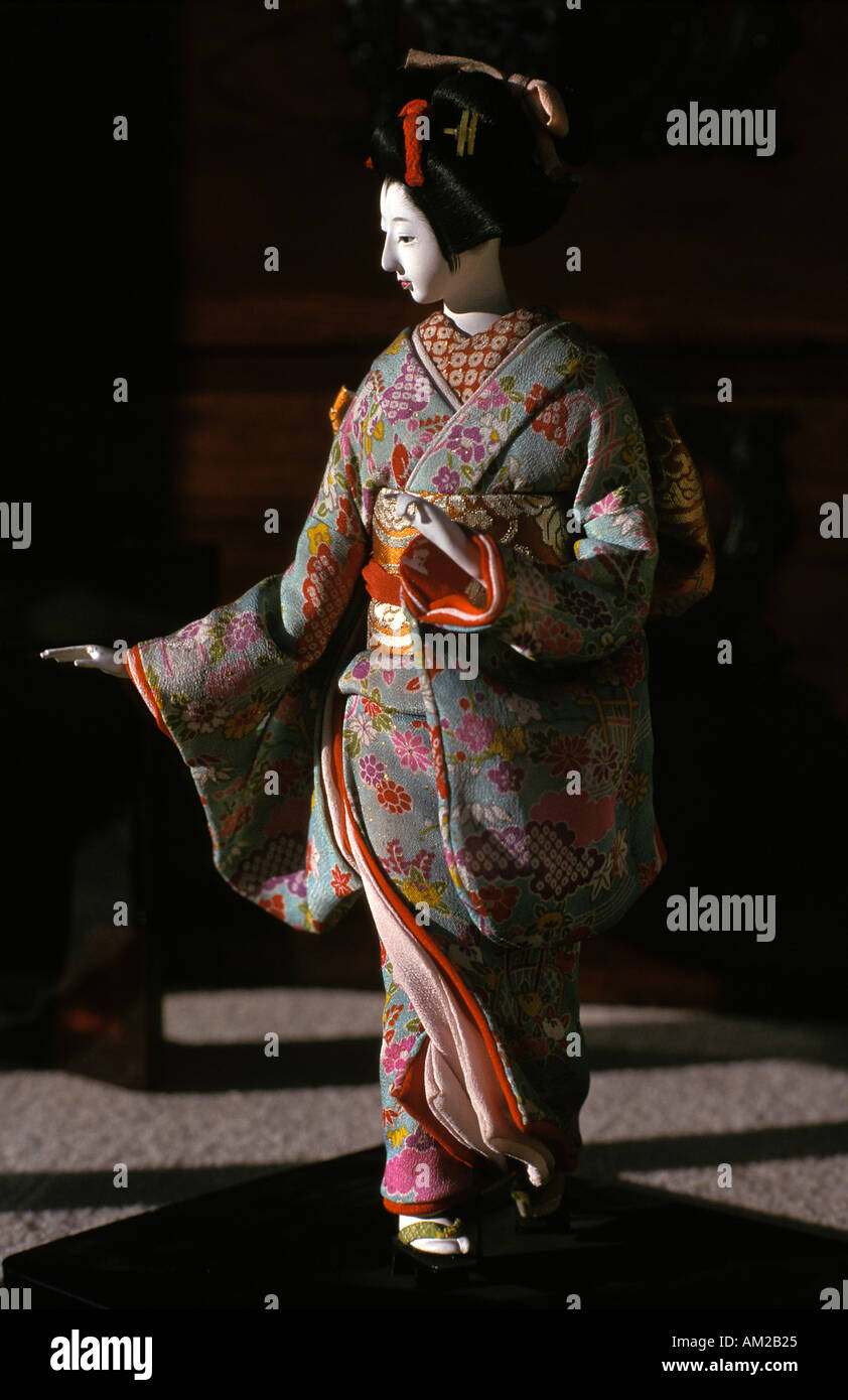 Carved Japanese doll dressed in silk kimono Antique shop Kyoto Japan Stock Photo