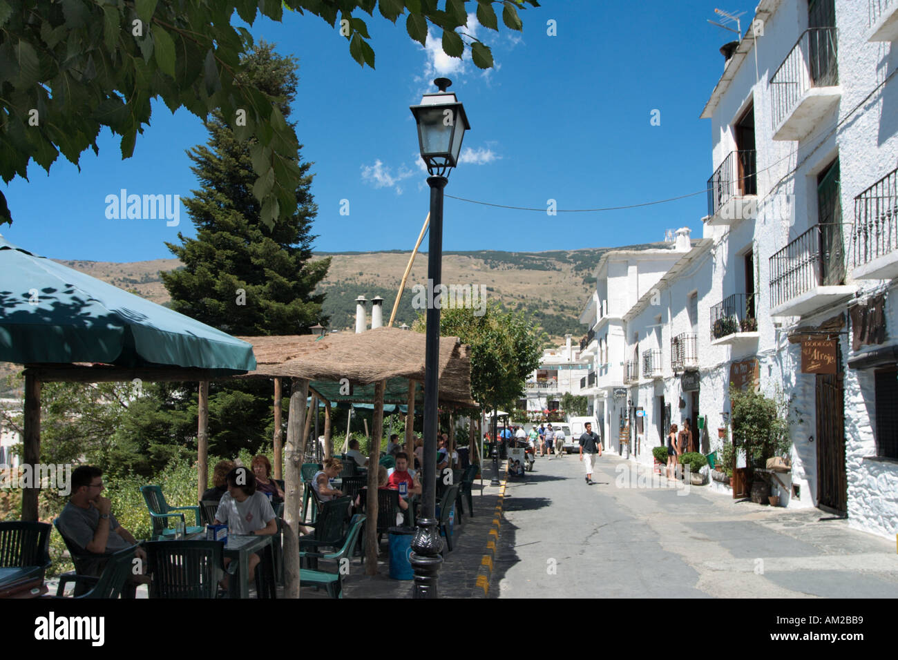 Pavement cafe and shops in the centre of the mountain village of Capileira, Las Alpujarras, Andalucia, Spain Stock Photo