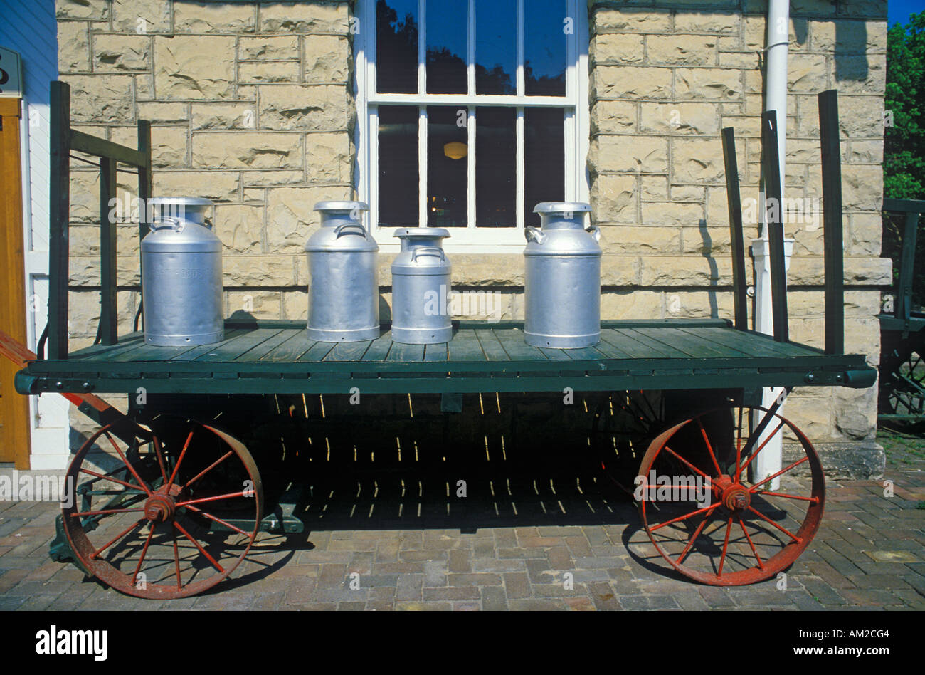 An old standard gauge steam engine car holds antique milk cans in Eureka Springs Arkansas Stock Photo