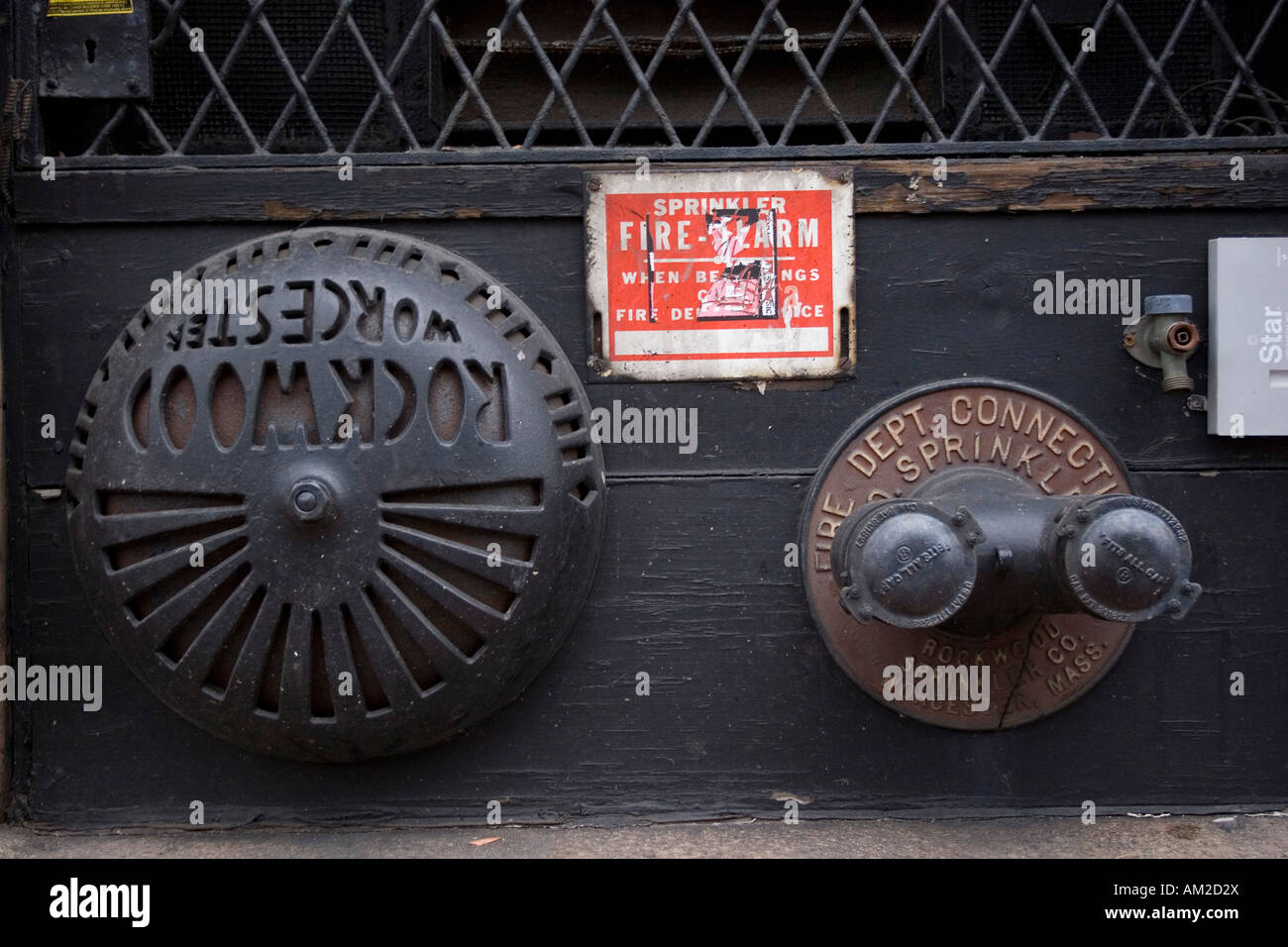 water hook up and alarm for fire of building. Side of building in the city of Boston Stock Photo