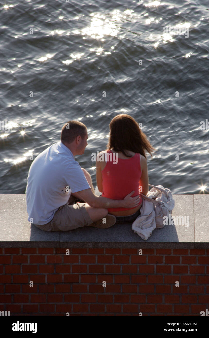 Young couple on the banks of the Wista (Vistula) river underneath the Wawel Royal Castle, Krakow, Poland. Stock Photo