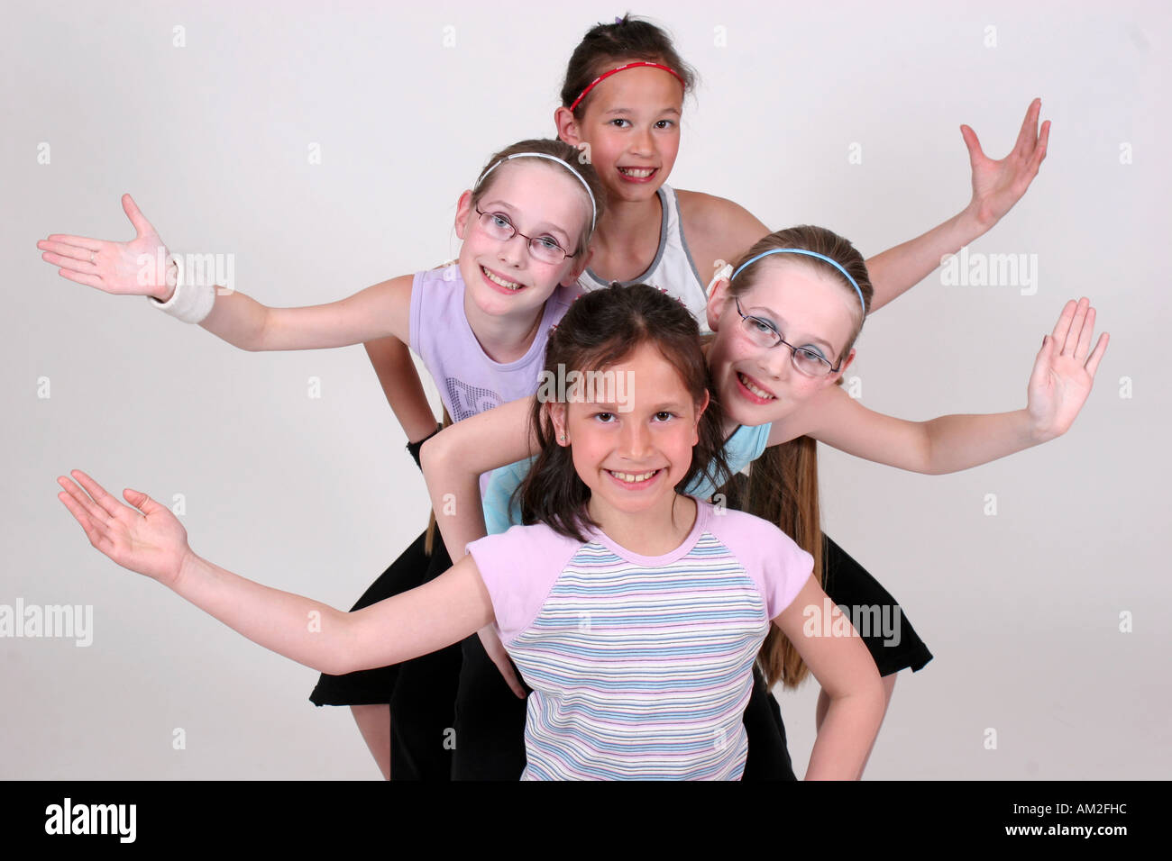 girls do pose and acrobat in white cutout background happy classmate kids acting Stock Photo