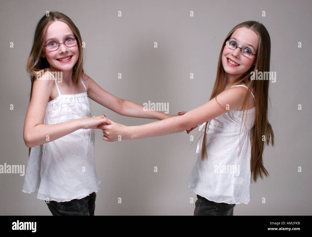 twin girl kid pose in white cutout background blond Caucasian European Stock Photo