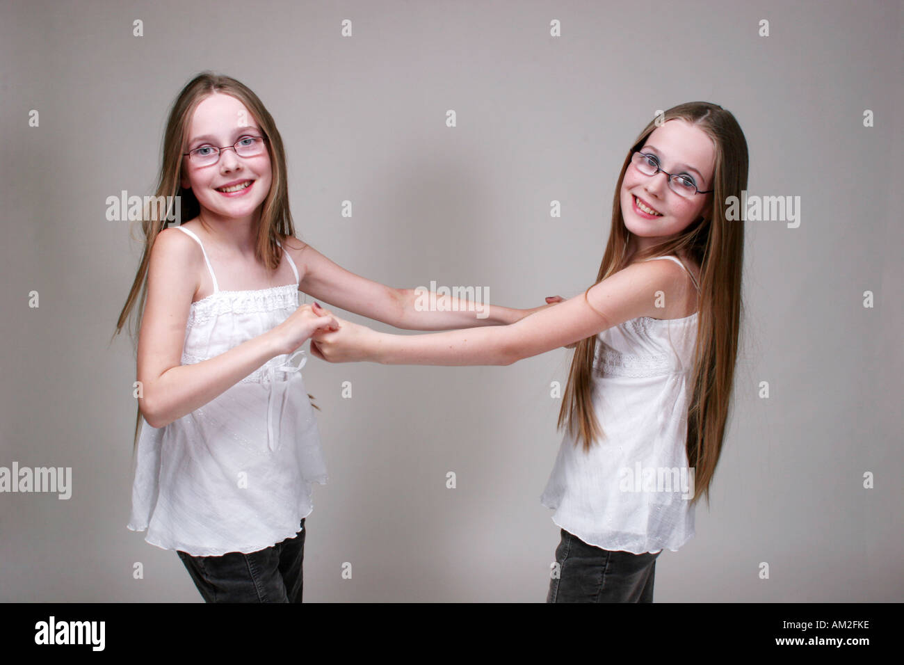 twin girl kid pose in white cutout background blond Caucasian European Stock Photo