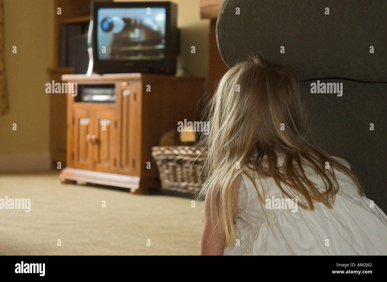Small girl hiding behind sofa watching a dalek on Dr Who bbc Stock Photo