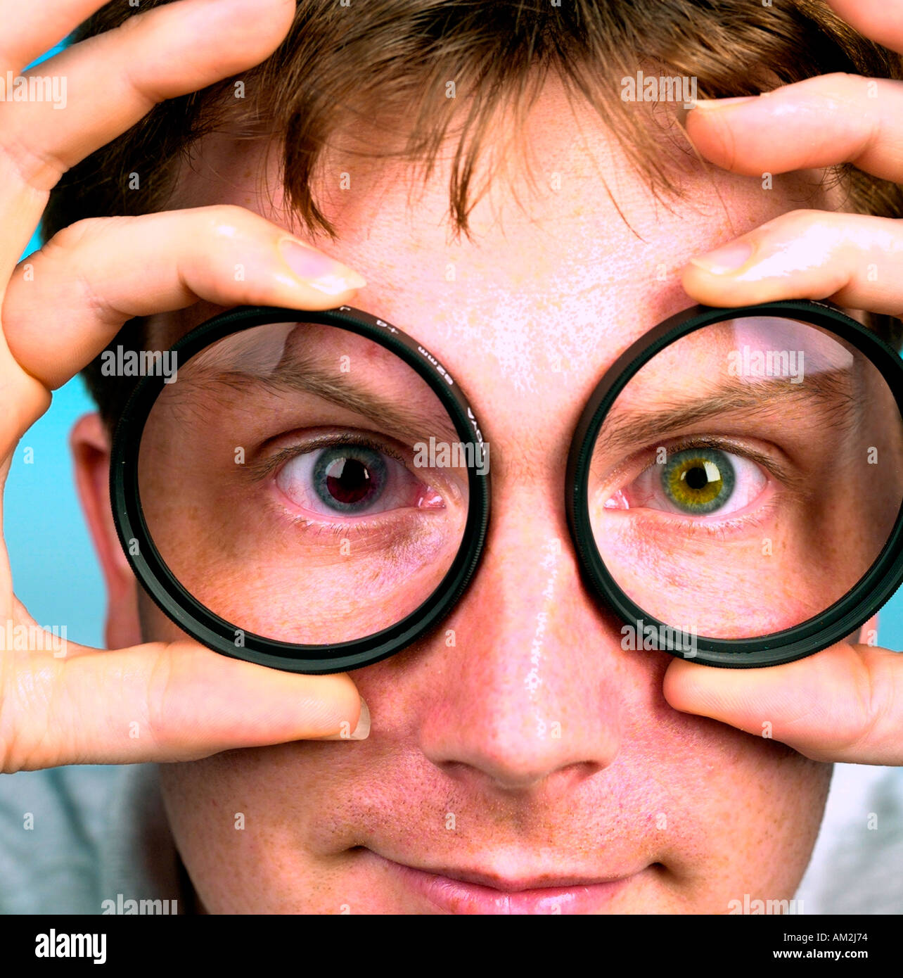 A PHOTOGRAPHER WEARING COLOURED CONTACT LENSES TO COUNTERACT HIS COLOUR