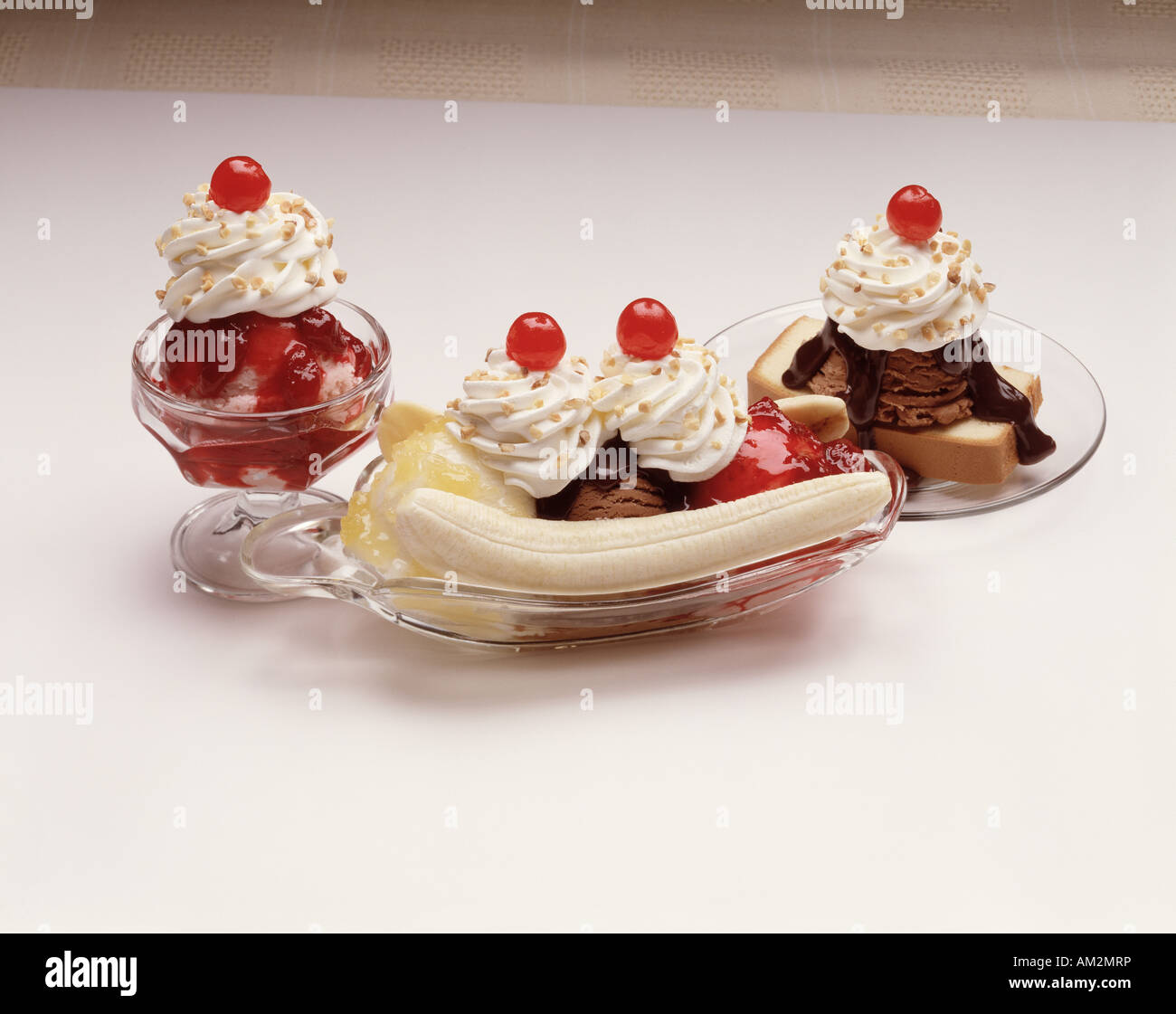 three glass dishes banana split strawberry ice cream sundae ...