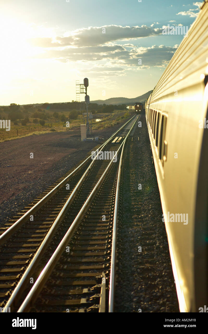 Passenger train traveling into the Arizona sunset Stock Photo Alamy