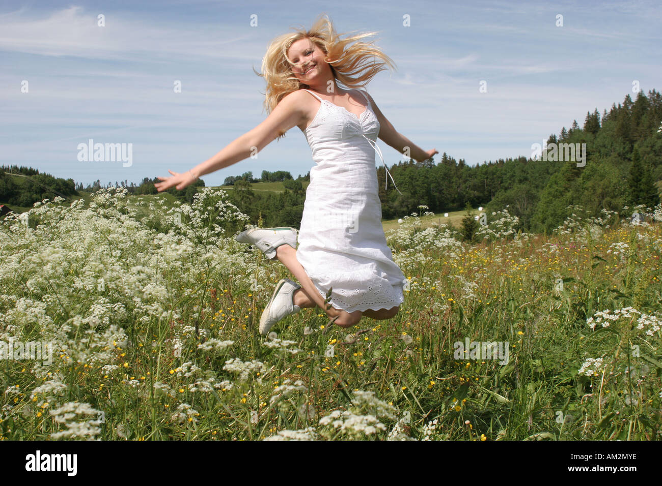 pretty young girl playing outside in the nature summer breeze C Stock Photo