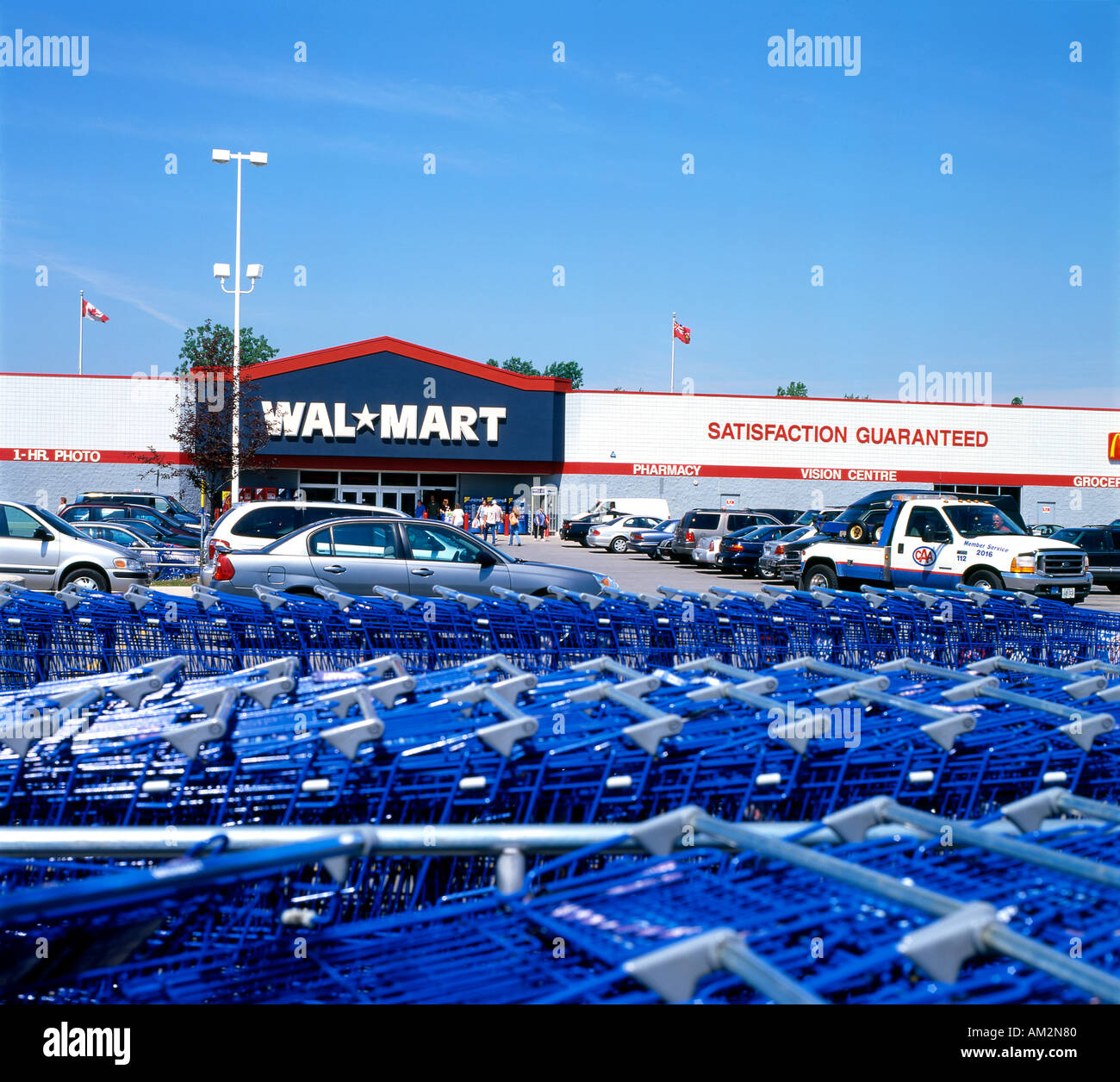 Walmart storefront exterior with blue shopping carts in the parking lot
