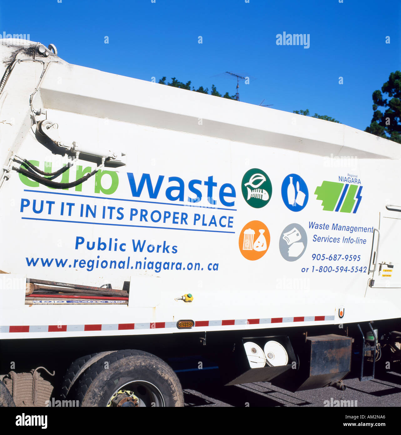 Curb side waste collection sign on the side of a Canadian Niagara region bin lorry garbage truck Fort Erie Ontario Canada North America  KATHY DEWITT Stock Photo