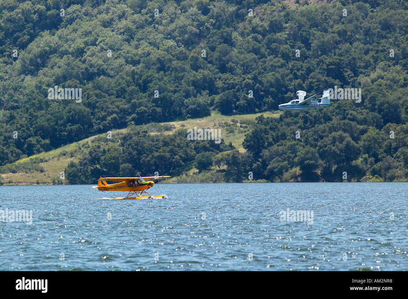 Two Amphibious seaplanes landing on Lake Casitas Ojai California Stock Photo