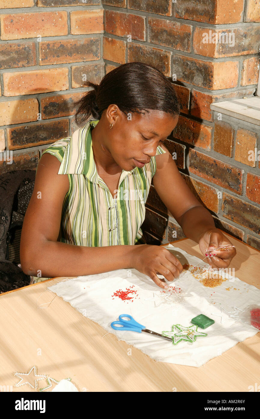 Bead embroiderer producing Christmas decorations, Cape Town, South Africa Stock Photo