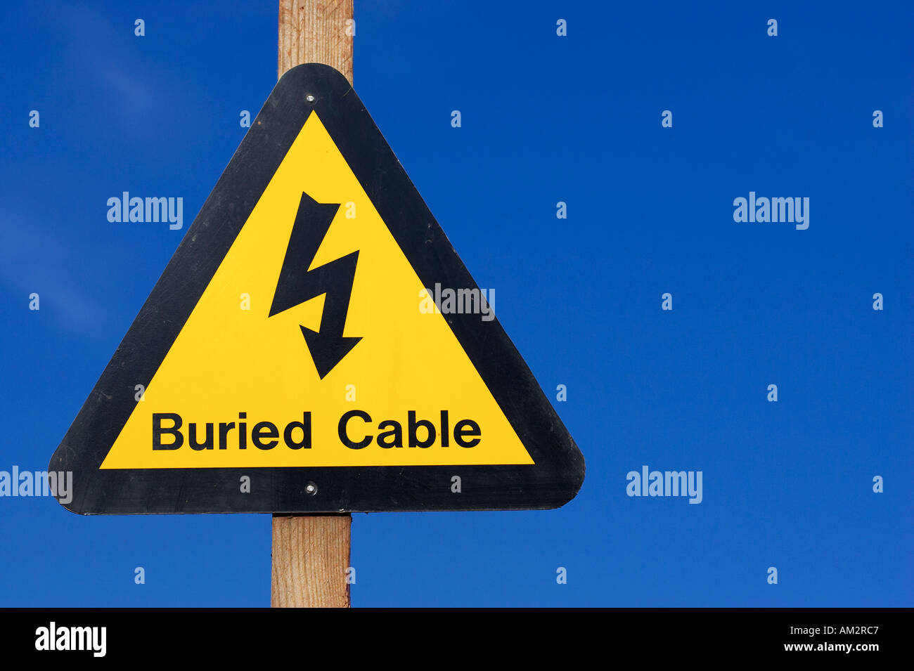 Yellow buried electrical cable warning sign at a quarry in the west midlands england uk Stock Photo
