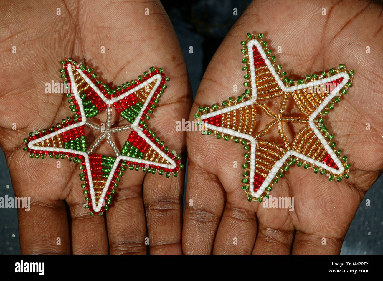 Hands with Christmas stars made of glass beads, Cape Town, South Africa