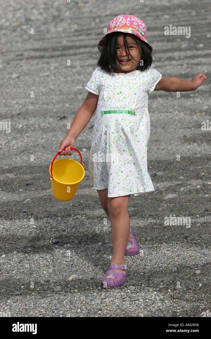 little girl walking at the beach Stock Photo