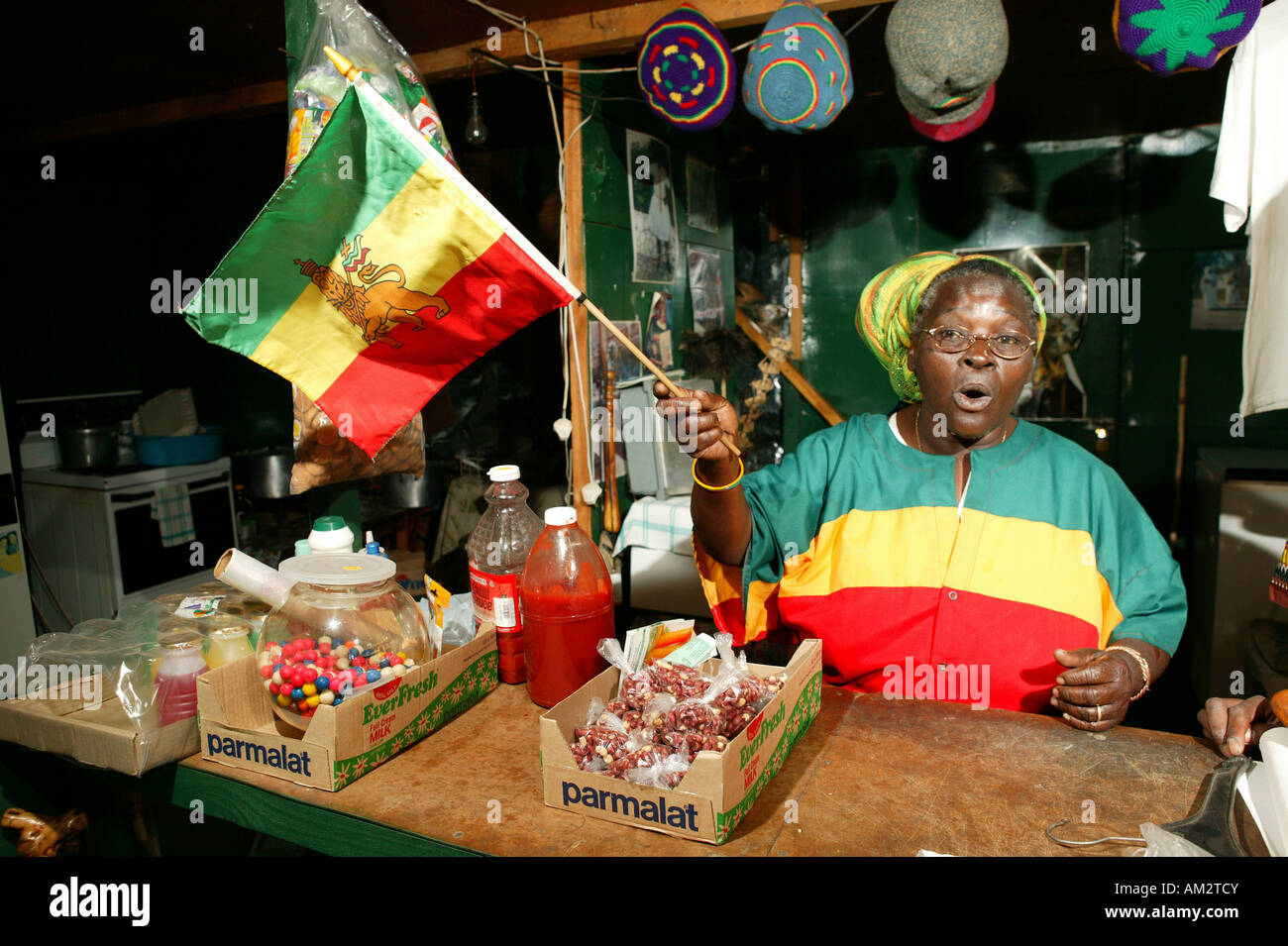 The chairwoman of the Rasta Marcus Garvey Community waving the Caribbean flag, Cape Town, South Africa Stock Photo