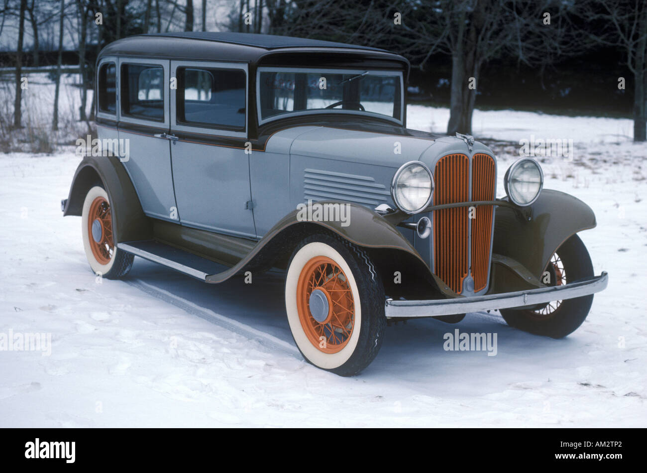 An antique car in the snow in New England Stock Photo
