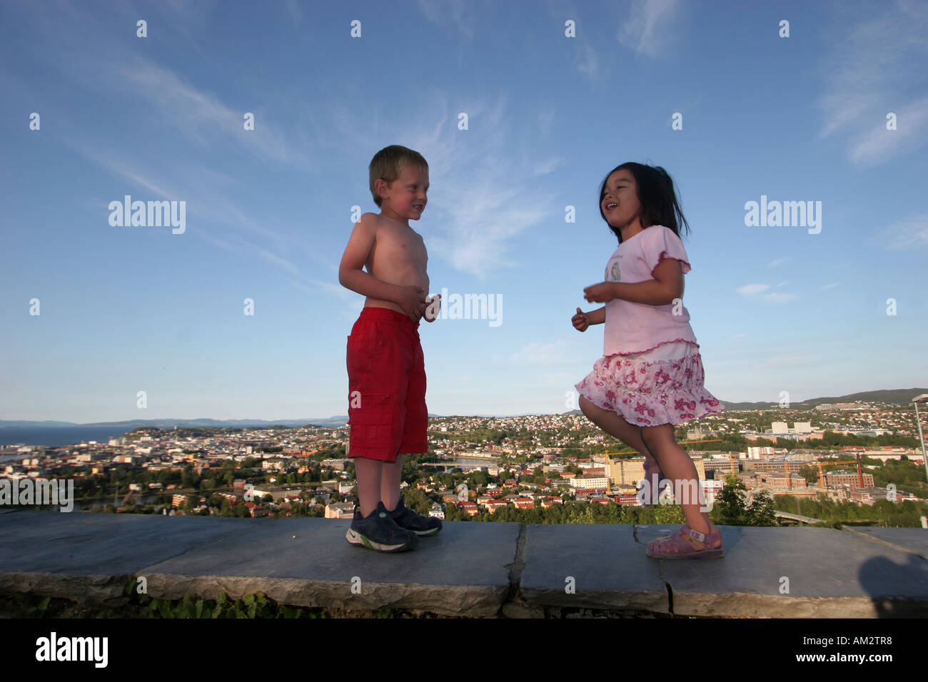 boy and girl playing wide low horizontal view Stock Photo