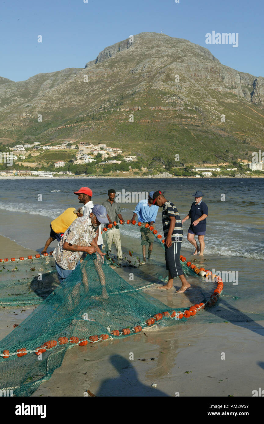 Fishermen on the beach with flues, Hout Bay, Cape Town, South Africa Stock Photo
